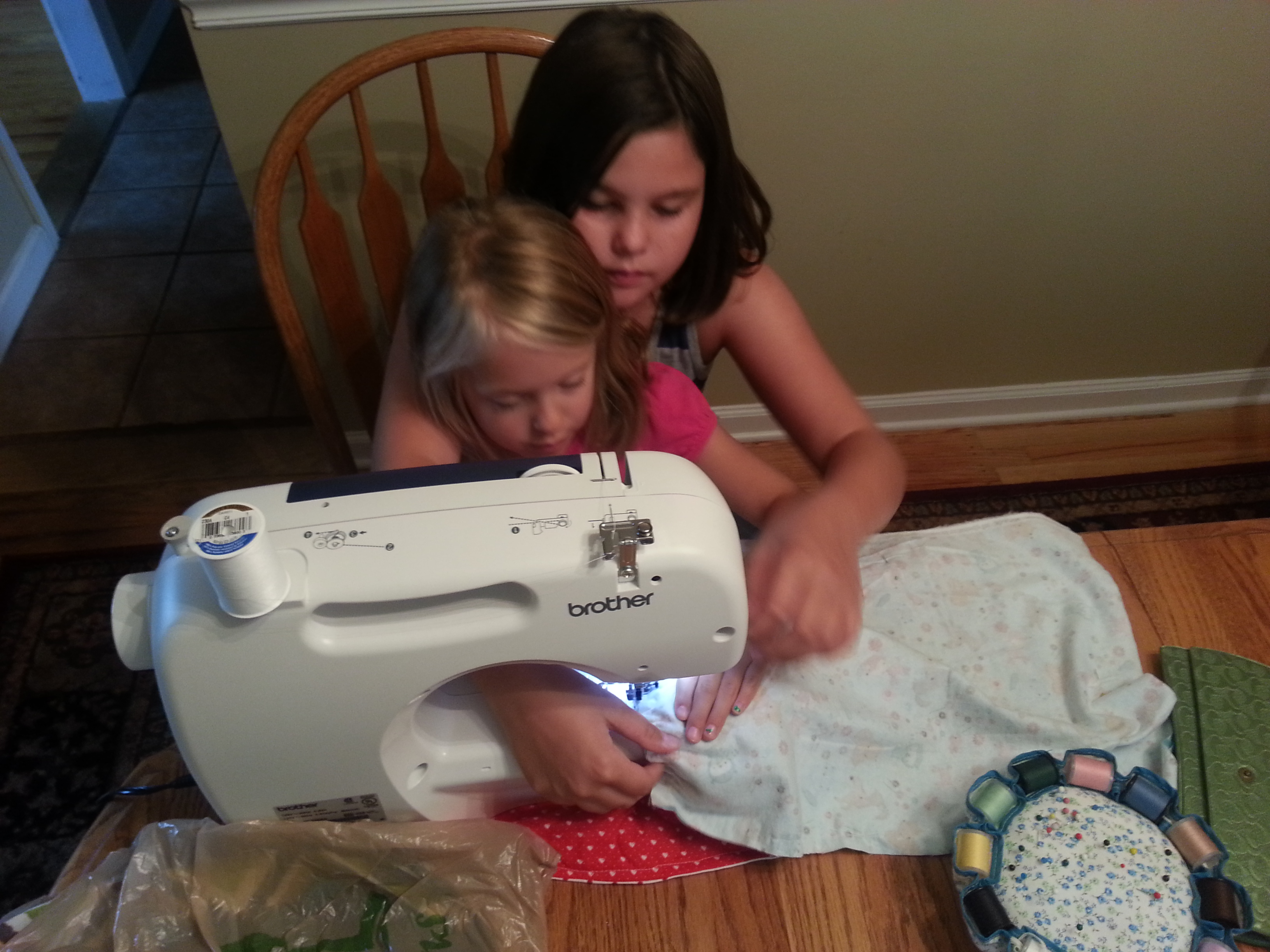 Me teaching my other cousin how to sew