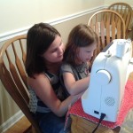 Me teaching my cousin how to sew